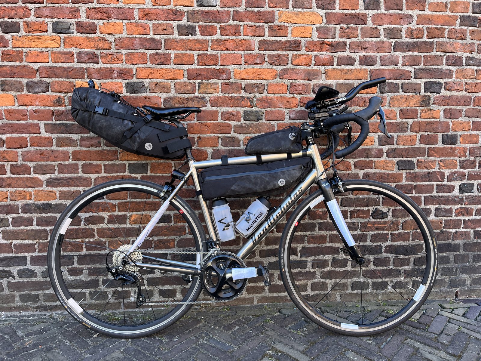 A loaded bikepacking setup with bottles and frame bags, the bike Jesse rode during the Race around the Netherlands 2026